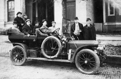 Men in an open touring car